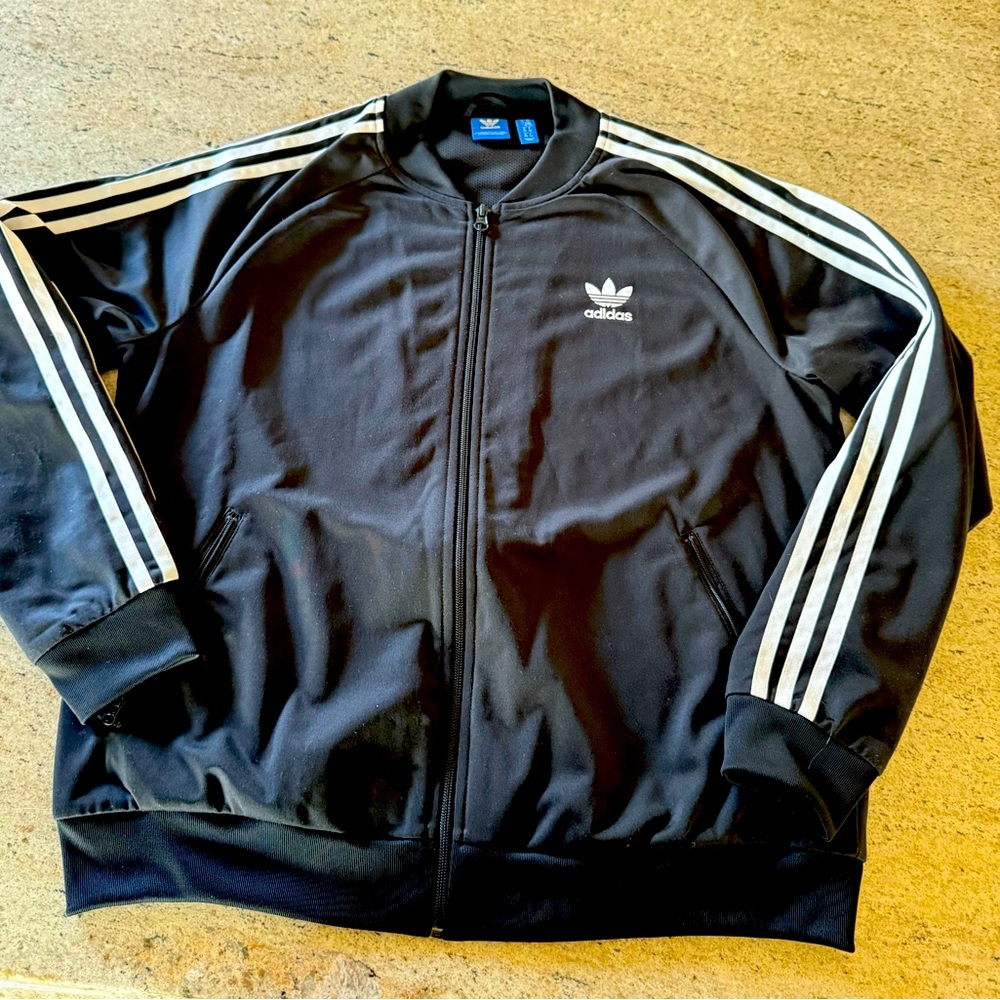 Black adidas track jacket 
Gently used . 
Size Xl womens
